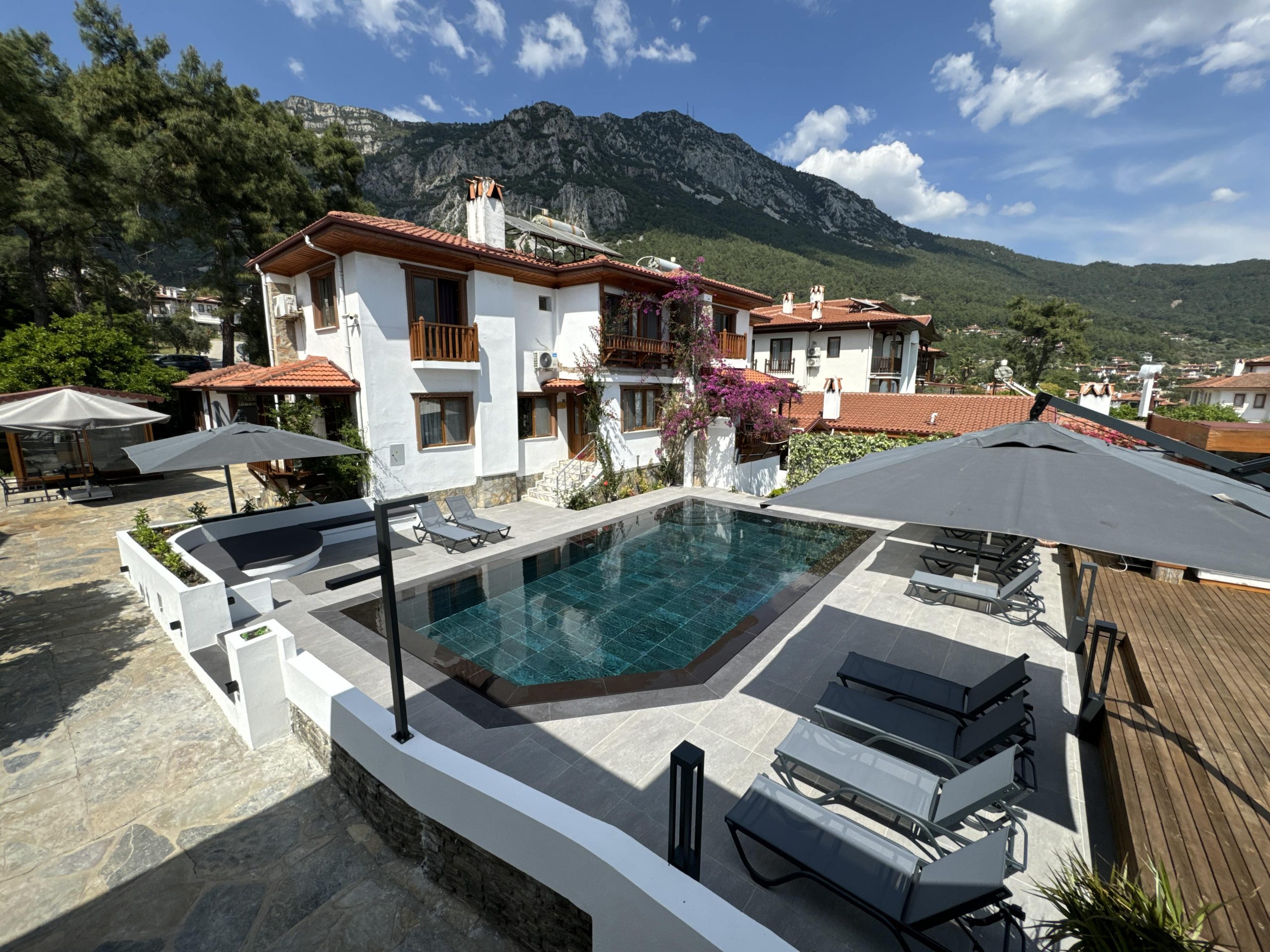 Tomsan Villas bahçesinde havuz kenarındaki evler